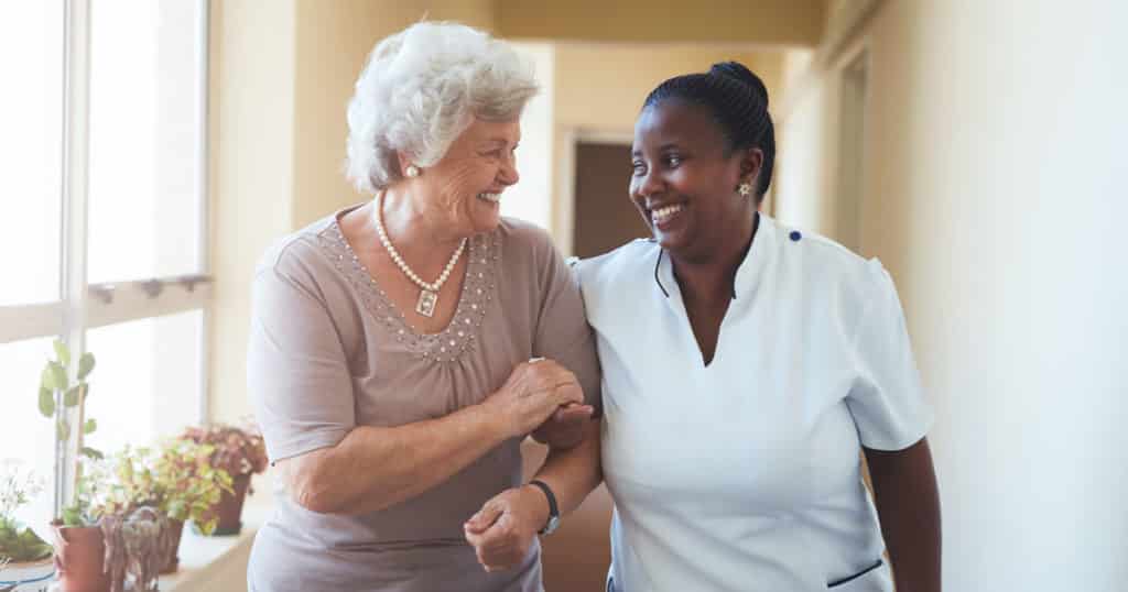 Continuing Care Retirement Community resident and staff walking together