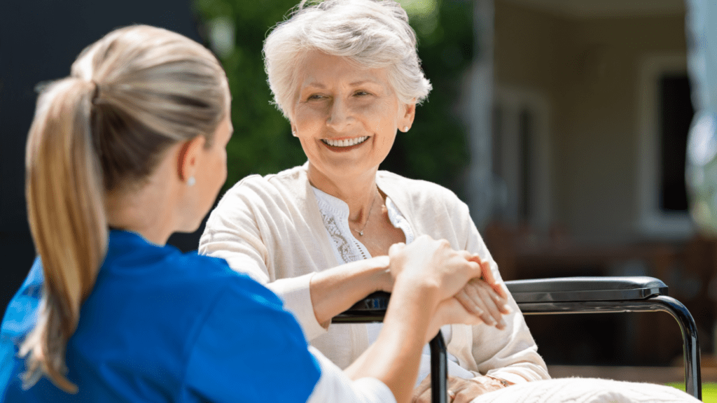 woman with her hand on a senior's hand