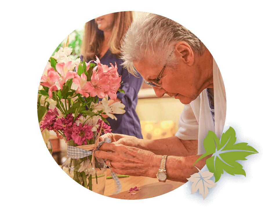 senior woman looking at bouquet of flowers