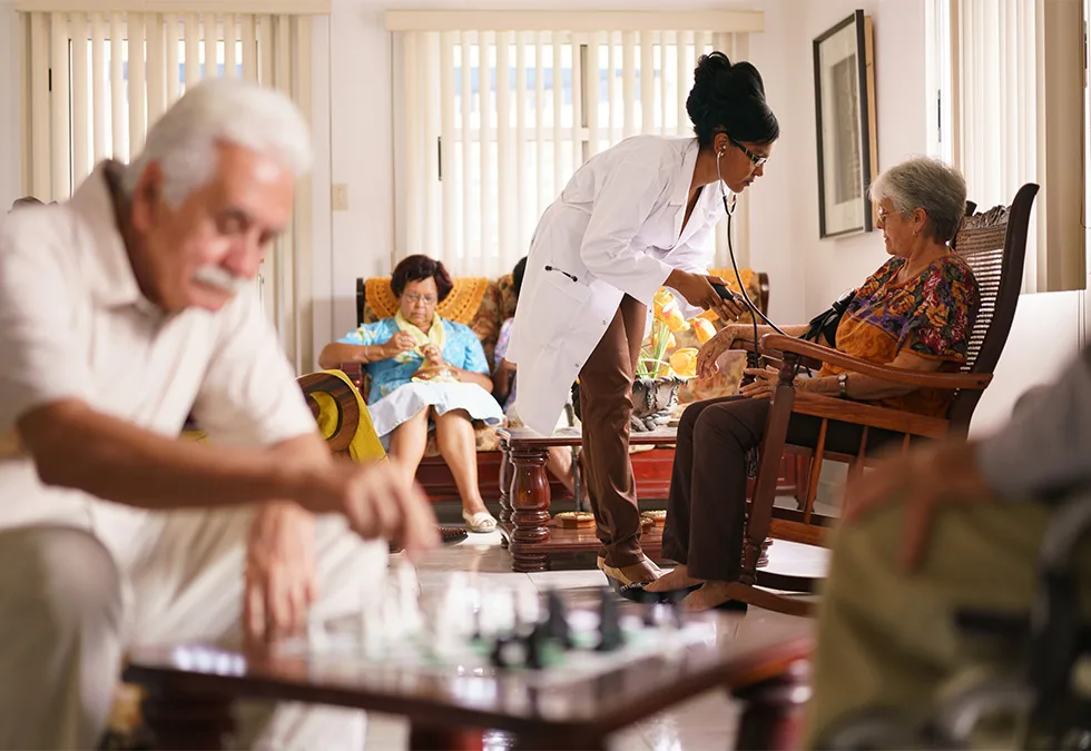 Woman taking the blood pressure of an elderly woman